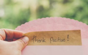 hand-hold-think-positive-message-brown-paper_38066-81-300x189